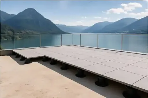 SkyJack fully assembled paver pedestal being set on rooftop deck