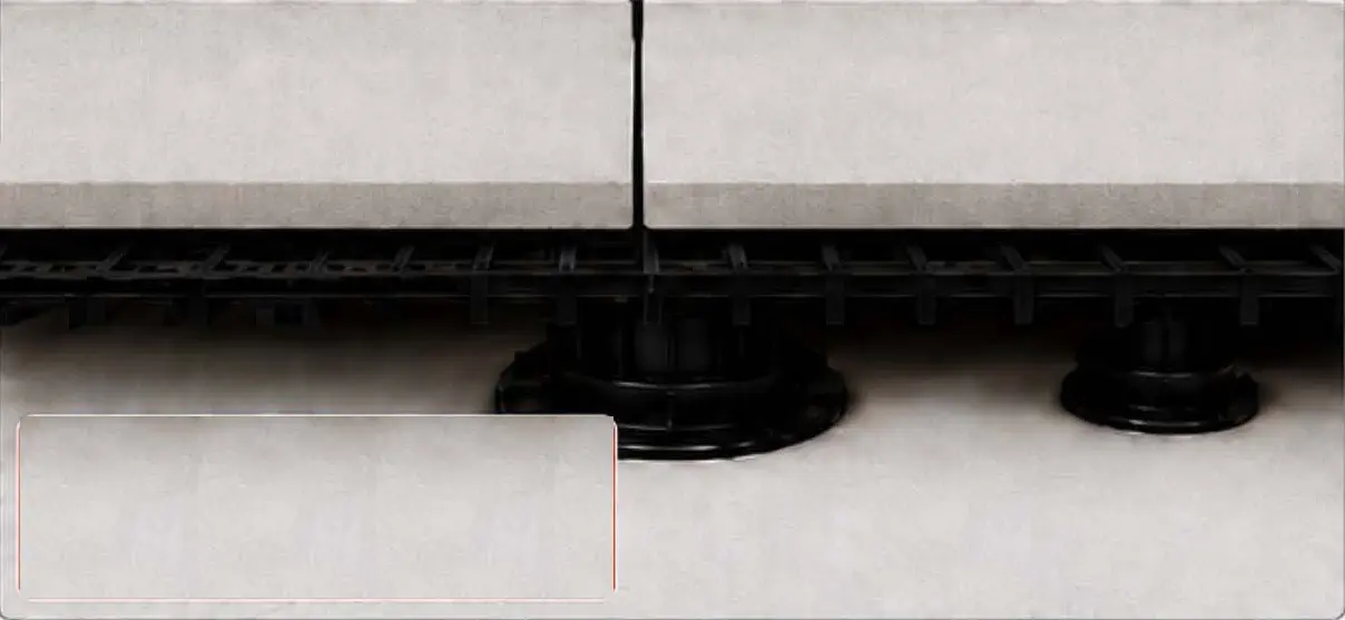 Plastic grate layer installed on pedestals beneath a porcelain paver